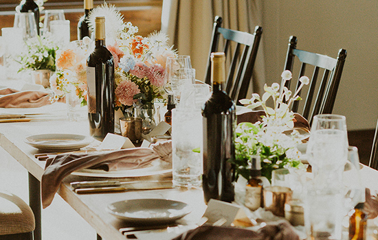 Dry Creek Vineyard wine bottles sitting on a wedding reception table, beautifully decorated