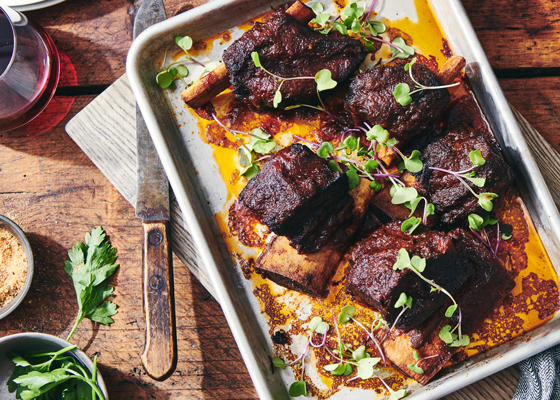 A baking tray filled with delicious short ribs covered in Don's BBQ sauce
