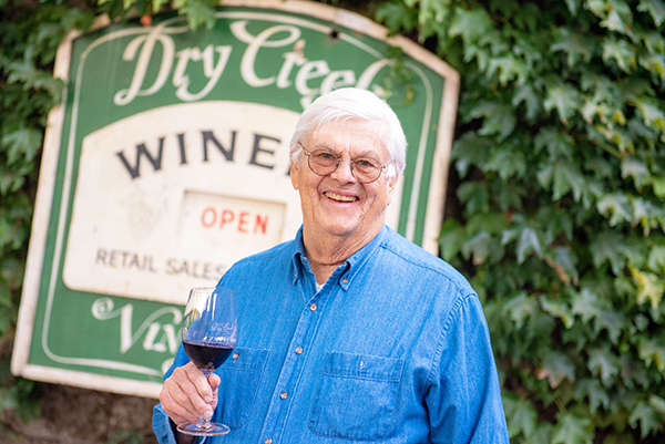 Founder David S. Stare stands in front of vintage winery sign